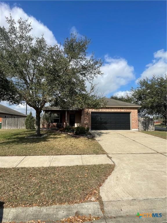 view of front of house featuring a garage and a front lawn