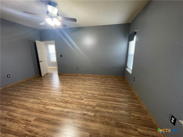 unfurnished room featuring ceiling fan, plenty of natural light, and hardwood / wood-style floors