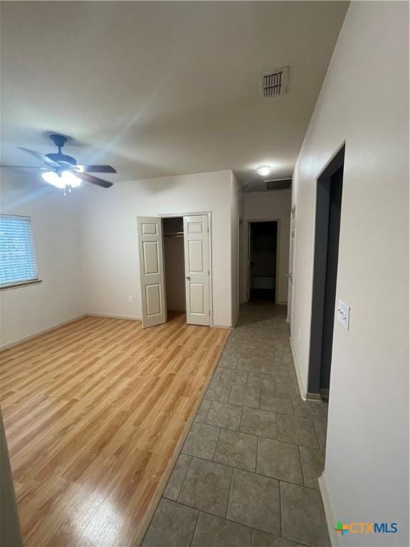 empty room with ceiling fan and wood-type flooring