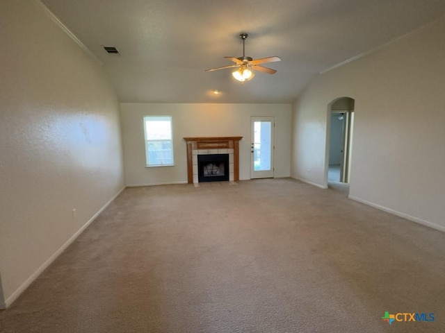 3601 Armstrong County Ct, Killeen, TX 76549 - unfurnished living room featuring vaulted ceiling, ceiling fan, arched walkways, baseboards, and a tile fireplace