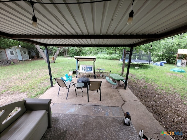 view of patio featuring a trampoline, a storage shed, an outdoor structure, a playground, and an outdoor hangout area