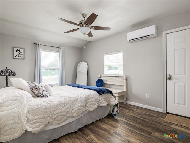 415 Brooks Mill Rd, Bertram, TX 78605 - bedroom with a wall mounted AC, multiple windows, wood finished floors, and a ceiling fan