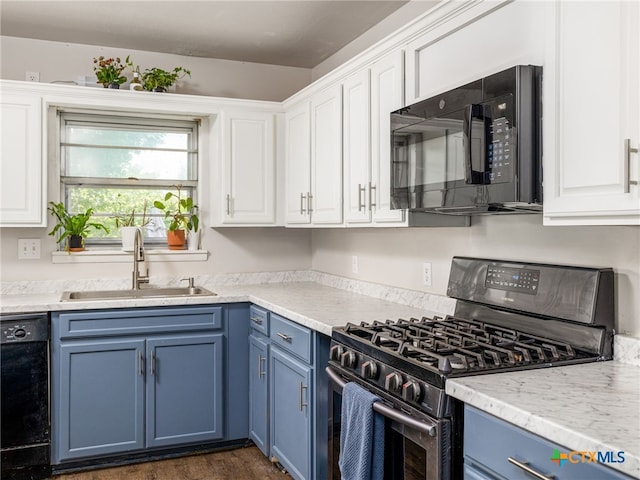 415 Brooks Mill Rd, Bertram, TX 78605 - kitchen with black appliances, blue cabinets, white cabinetry, and dark wood-style floors