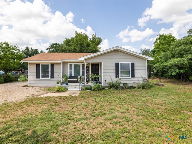 415 Brooks Mill Rd, Bertram, TX 78605 - ranch-style home with a front lawn