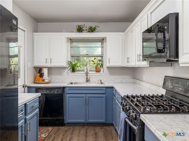 415 Brooks Mill Rd, Bertram, TX 78605 - kitchen with black appliances, blue cabinets, and white cabinetry