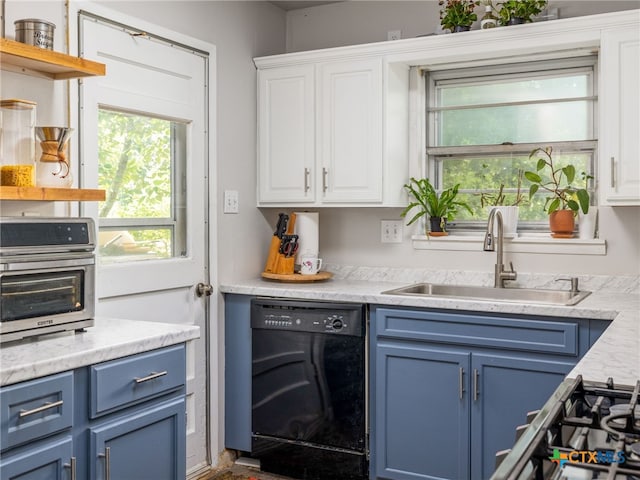 415 Brooks Mill Rd, Bertram, TX 78605 - kitchen with black dishwasher, blue cabinets, white cabinets, and plenty of natural light