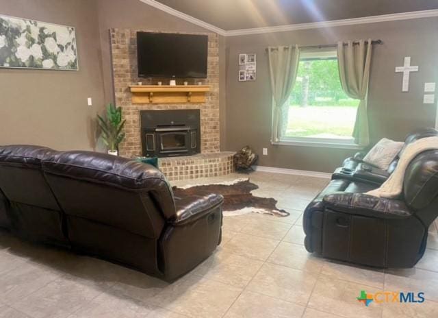 living area with light tile patterned floors, baseboards, ornamental molding, and vaulted ceiling