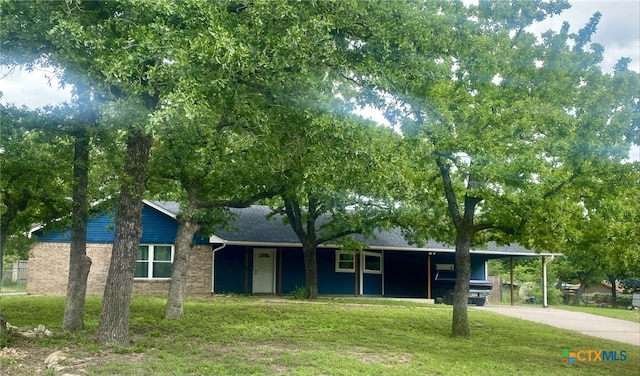 ranch-style home with concrete driveway, a front lawn, an attached carport, and brick siding