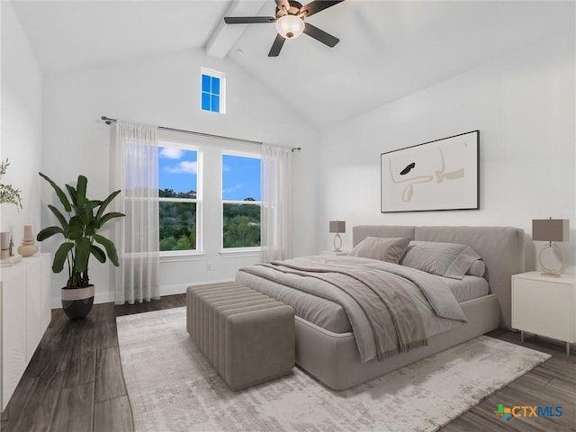 bedroom featuring ceiling fan, hardwood / wood-style floors, and lofted ceiling with beams