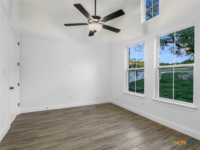 spare room featuring ceiling fan and dark hardwood / wood-style flooring