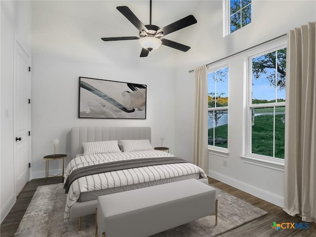 bedroom featuring ceiling fan and dark wood-type flooring