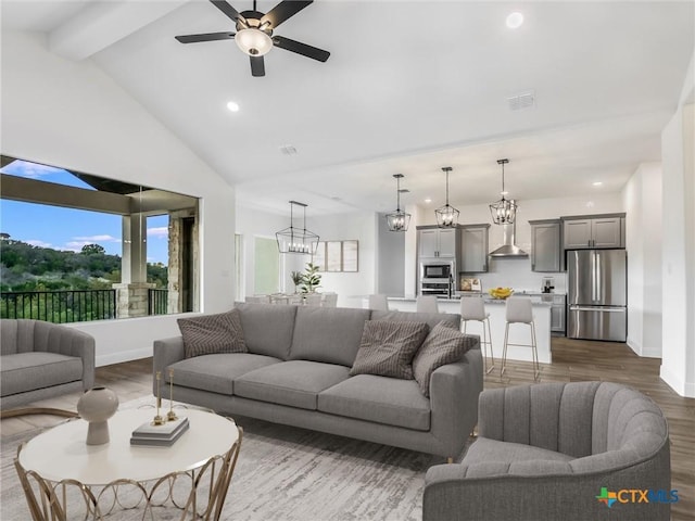 living room with dark wood-type flooring, vaulted ceiling with beams, and ceiling fan