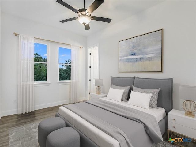 bedroom with ceiling fan and dark wood-type flooring