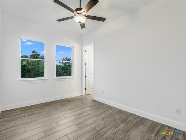 spare room with ceiling fan and light hardwood / wood-style flooring