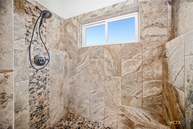 bathroom with a tile shower