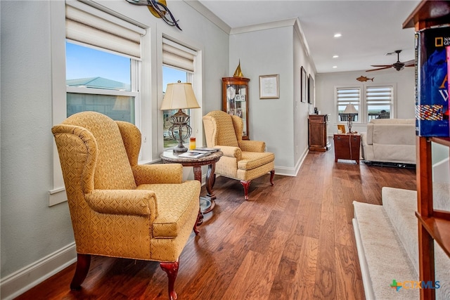 sitting room featuring ornamental molding, hardwood / wood-style floors, and ceiling fan