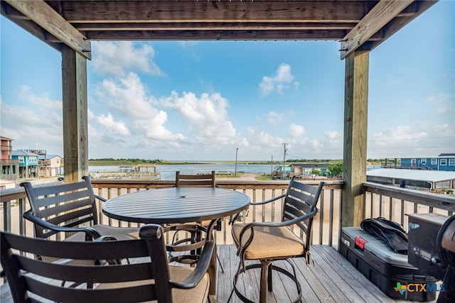 wooden terrace featuring a water view