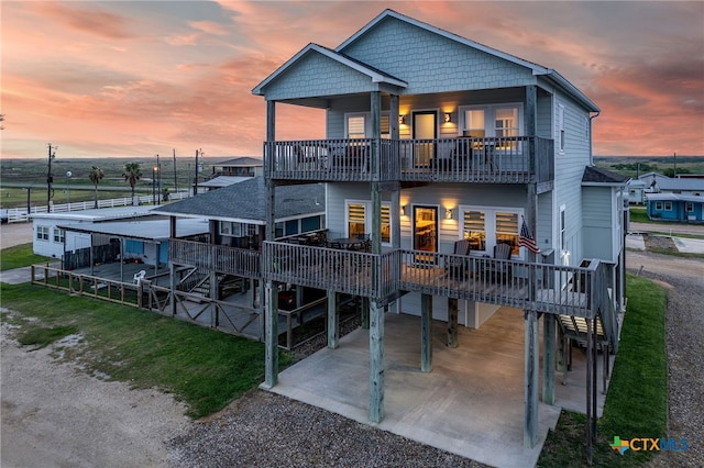 view of front of property featuring a carport and a balcony