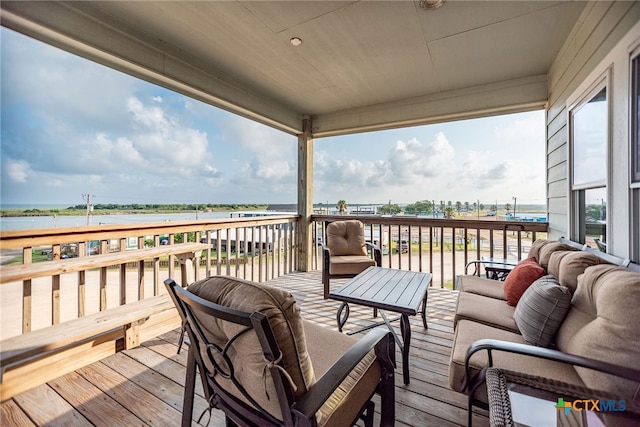 wooden deck featuring outdoor lounge area and a water view