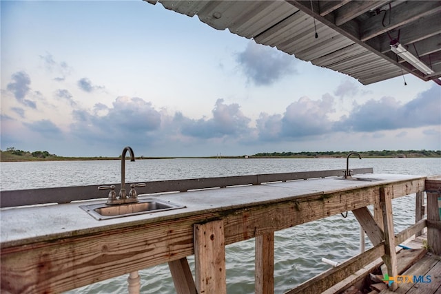 view of dock with a water view and sink