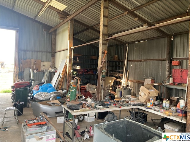 garage featuring wooden walls and a workshop area