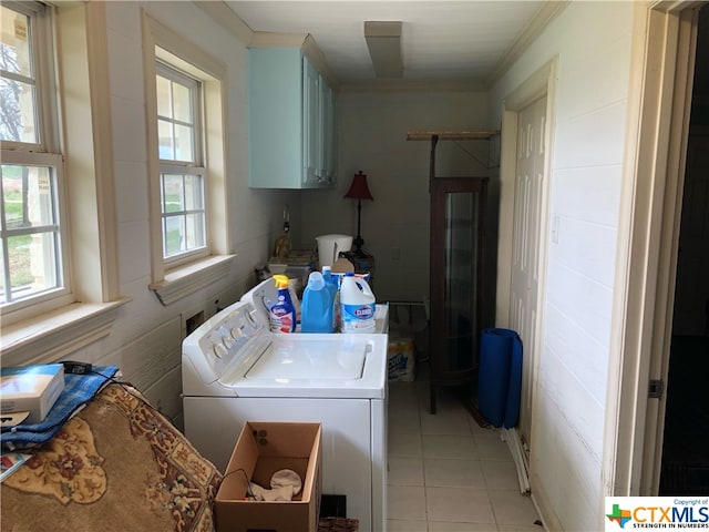 laundry area featuring separate washer and dryer, cabinets, crown molding, and light tile patterned floors