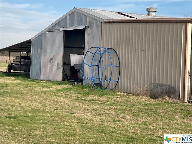 view of outbuilding with a yard