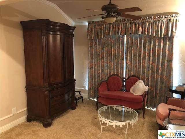 living area with light colored carpet, ceiling fan, and crown molding