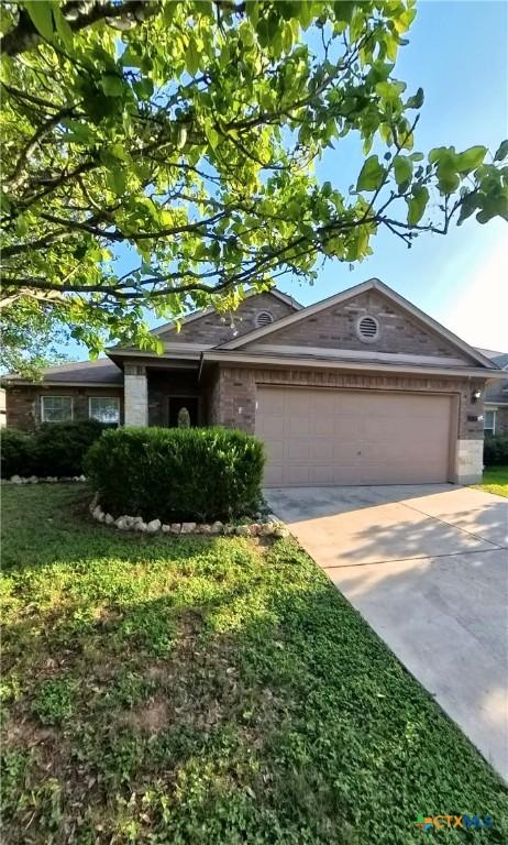 8710 Jogeva Way, San Antonio, TX 78251 - single story home featuring a garage, concrete driveway, and brick siding