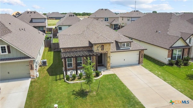 7005 Mcgregor Loop, Killeen, TX 76549 - view of front facade featuring stone siding, a residential view, driveway, and roof with shingles