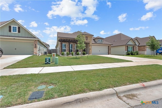 7005 Mcgregor Loop, Killeen, TX 76549 - view of front of property featuring concrete driveway, board and batten siding, a front lawn, and brick siding