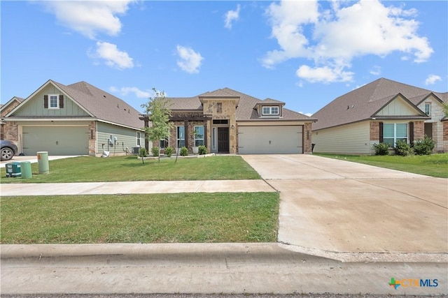 7005 Mcgregor Loop, Killeen, TX 76549 - view of front of house featuring brick siding, a front yard, concrete driveway, a garage, and board and batten siding