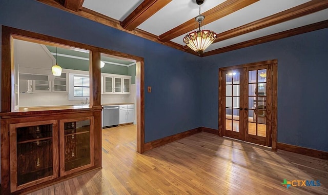 905 N 33rd St, Waco, TX 76707 - spare room with french doors, wood finished floors, and beam ceiling