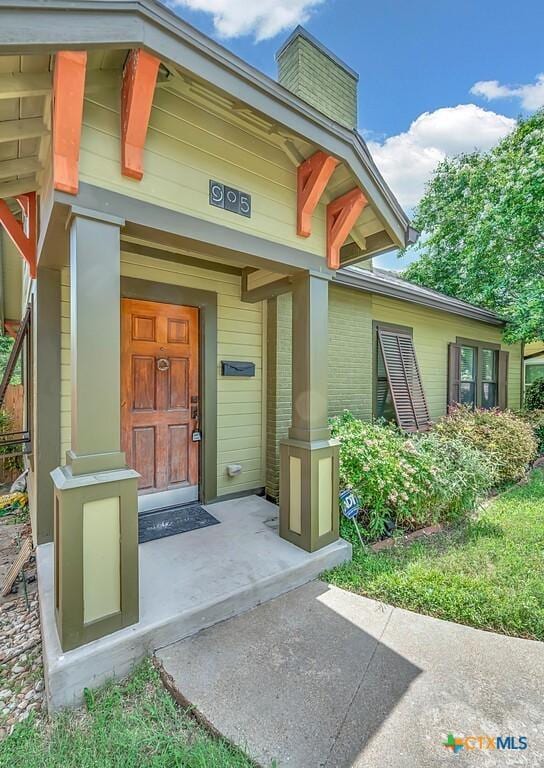 905 N 33rd St, Waco, TX 76707 - property entrance with a chimney and brick siding