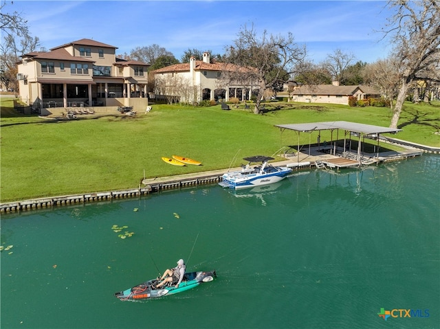 exterior space featuring a lawn and a water view