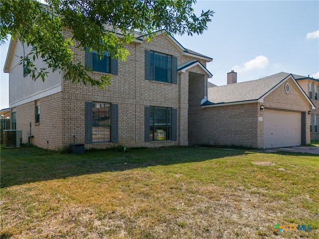 view of front of property featuring a front yard, a garage, and cooling unit