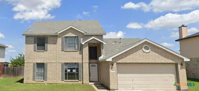 view of front facade with a front yard and a garage