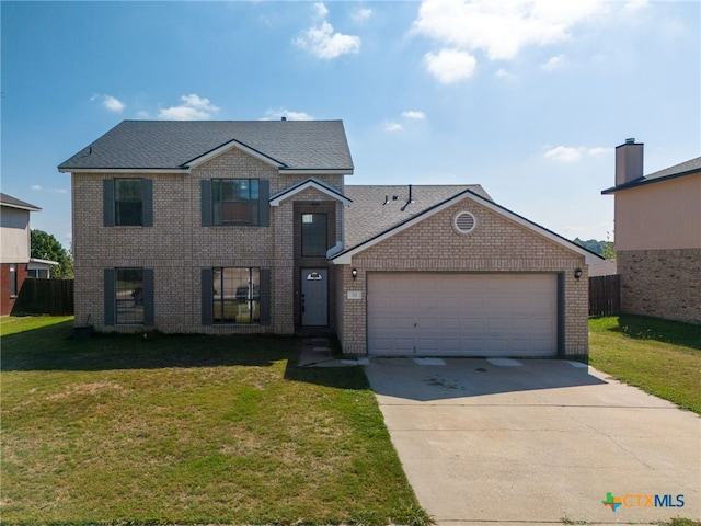 view of front of property featuring a front yard and a garage