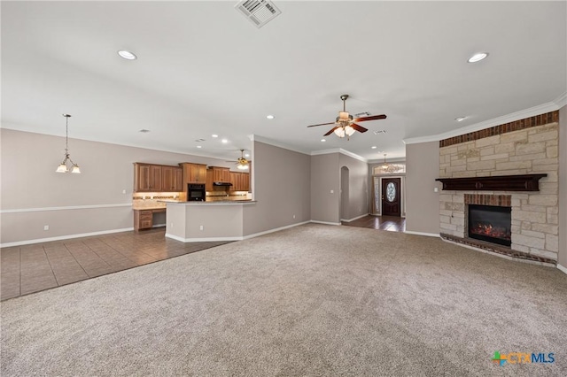 2206 Pheasant Run Ln, Temple, TX 76502 - unfurnished living room with carpet floors, a ceiling fan, recessed lighting, crown molding, and a stone fireplace