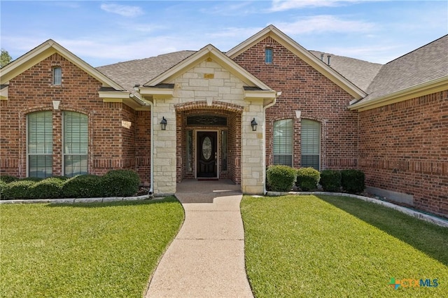 2206 Pheasant Run Ln, Temple, TX 76502 - view of front of home featuring a front lawn, a shingled roof, and stone siding