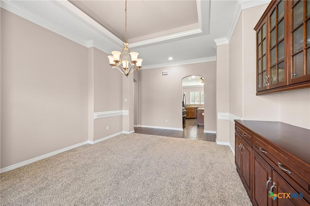 2206 Pheasant Run Ln, Temple, TX 76502 - unfurnished room featuring light colored carpet, arched walkways, a chandelier, a tray ceiling, and crown molding