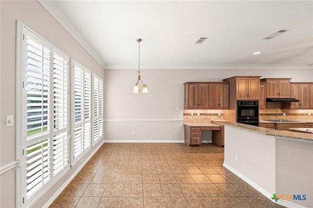 2206 Pheasant Run Ln, Temple, TX 76502 - kitchen with healthy amount of natural light, decorative backsplash, light tile patterned floors, under cabinet range hood, and ornamental molding