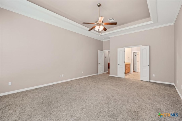 2206 Pheasant Run Ln, Temple, TX 76502 - unfurnished bedroom featuring a tray ceiling, crown molding, light carpet, and ensuite bathroom