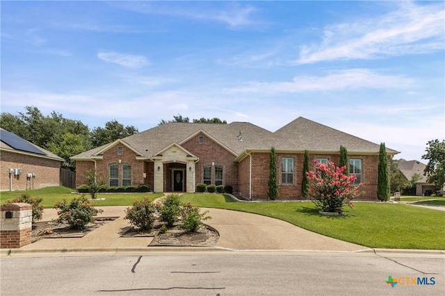 2206 Pheasant Run Ln, Temple, TX 76502 - view of front facade with brick siding, a front lawn, and curved driveway