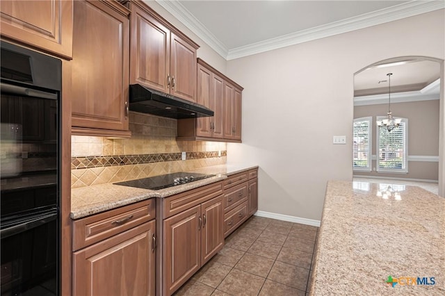 2206 Pheasant Run Ln, Temple, TX 76502 - kitchen with under cabinet range hood, black appliances, decorative backsplash, arched walkways, and crown molding