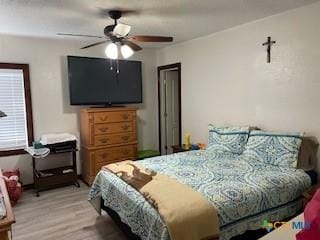 304 Oak Plz, Austin, TX 78753 - bedroom featuring light wood-style floors and a ceiling fan