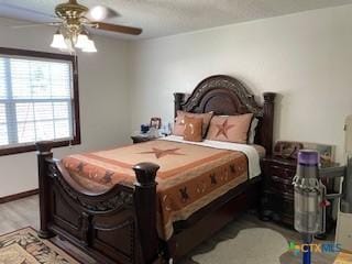 304 Oak Plz, Austin, TX 78753 - bedroom with wood finished floors, ceiling fan, and baseboards