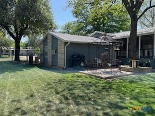 304 Oak Plz, Austin, TX 78753 - rear view of house with a lawn and a patio