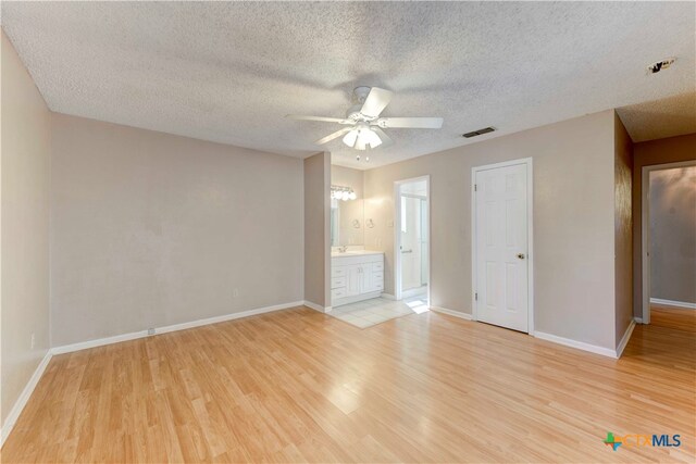 interior space featuring a textured ceiling and light wood-type flooring