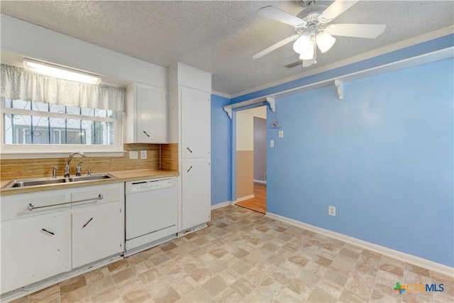 kitchen featuring white cabinetry, a textured ceiling, white dishwasher, sink, and ceiling fan